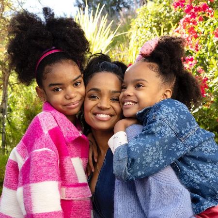 Lyric Kai Kilpatrick posing for a photo with her mother, Kyla Pratt and her younger sister, Liyah Kilpatrick.
